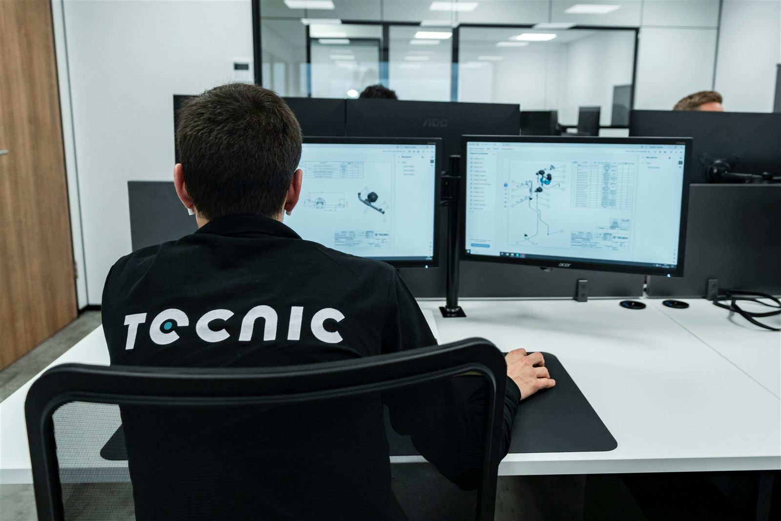 Engineer working at a dual-screen CAD workstation