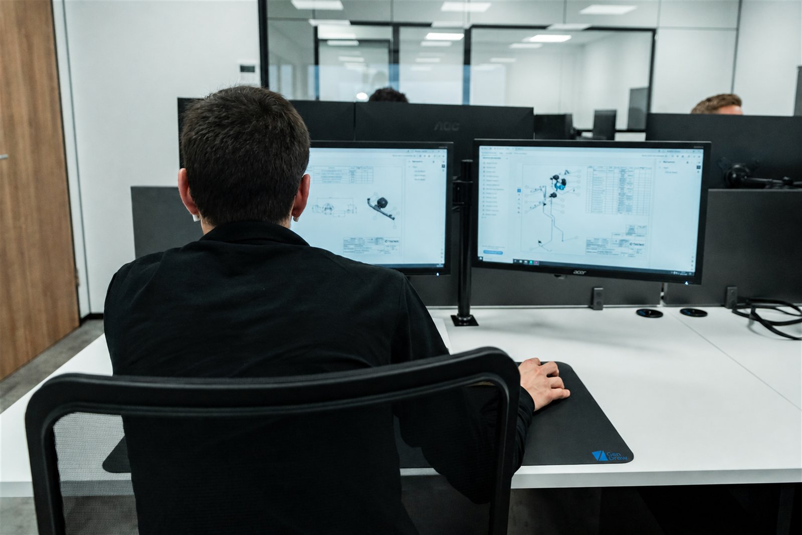 Engineer working at a dual-screen CAD workstation